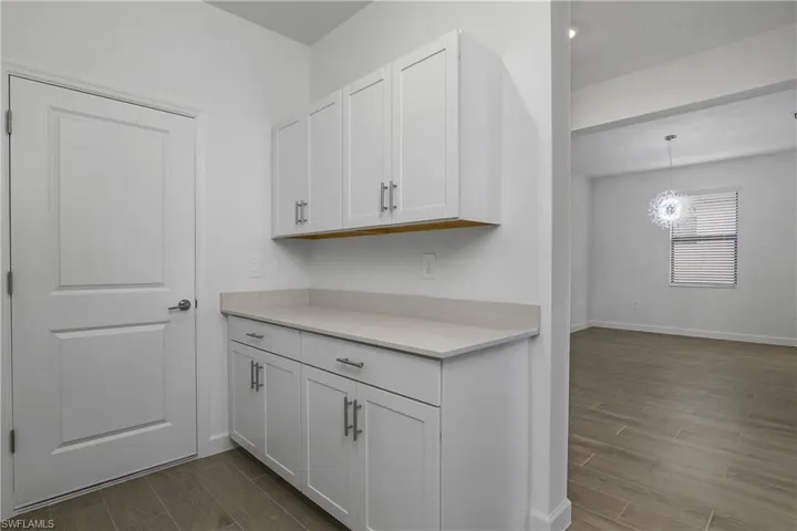 Drop zone at the garage entry includes after-market cabinetry for additional storage space.