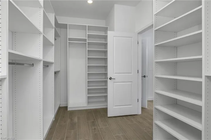 Owner suite with entry to HUGE walk-through closet with custom shelving, includes easy access to the laundry room!!