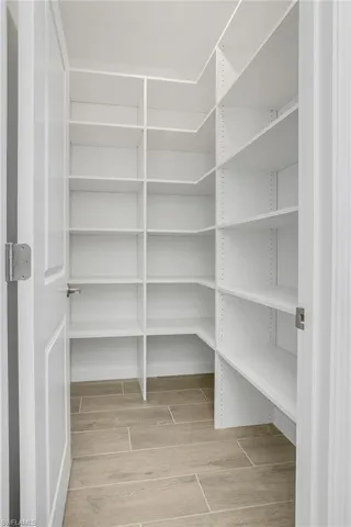 You'll love the coffee bar/butler pantry walk through area adjacent to the walk-in pantry with custom shelving.