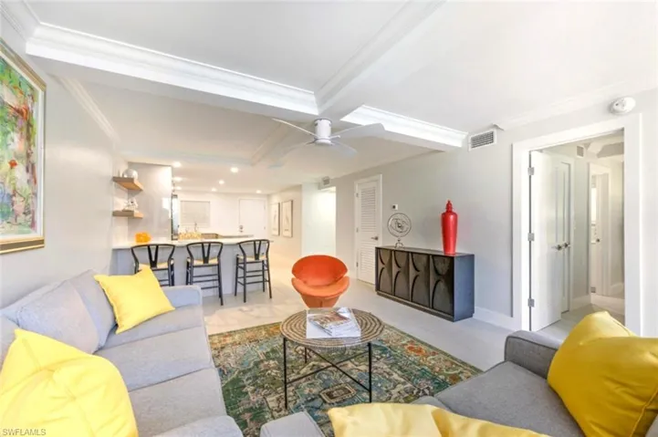 Living room with ceiling fan and crown molding