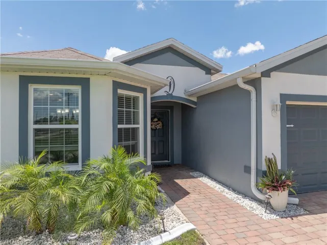 Entrance to property featuring stucco siding and an attached garage