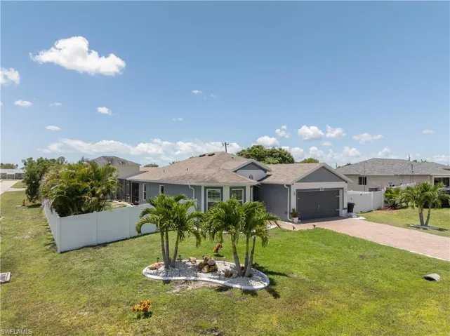 Ranch-style home with an attached garage, decorative driveway, and stucco siding