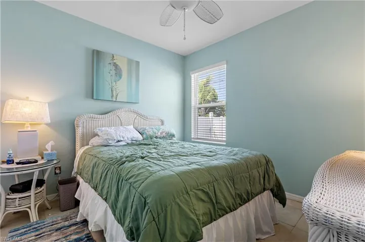 Bedroom featuring ceiling fan and baseboards