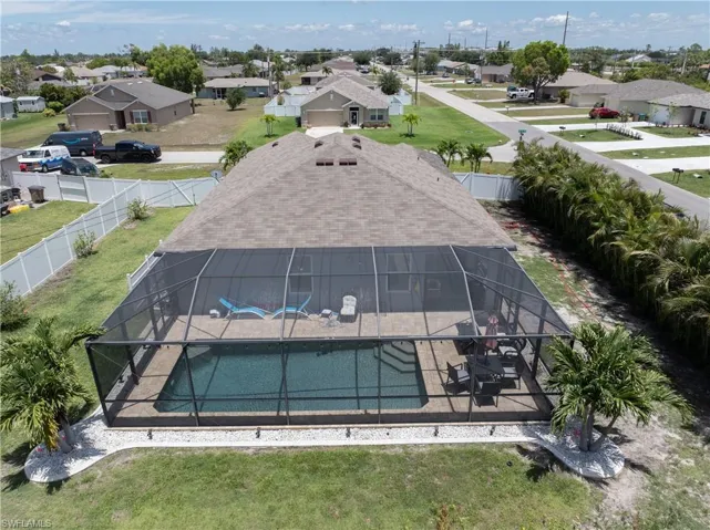 Aerial perspective of suburban area with a pool area