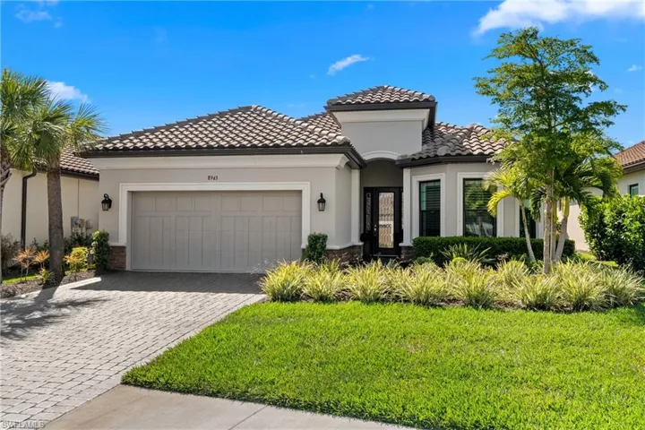 Mediterranean / spanish house featuring a tile roof, decorative driveway, a garage, and stucco siding
