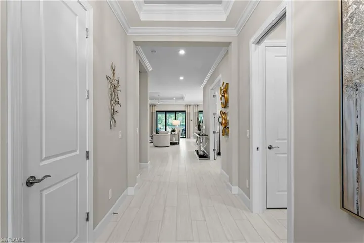 Hallway featuring recessed lighting, baseboards, and ornamental molding