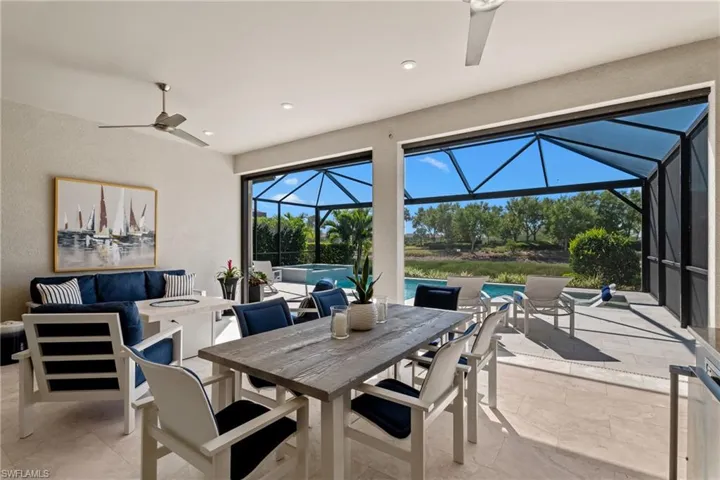 View of patio / terrace with glass enclosure, outdoor dining area, a ceiling fan, and an outdoor living space with a fire pit