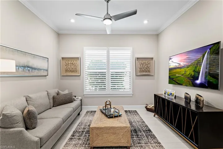 Living room with recessed lighting, a ceiling fan, crown molding, and baseboards