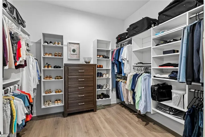 Spacious closet featuring hardwood / wood-style flooring