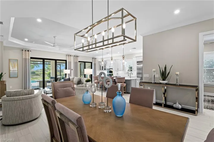 Dining room with crown molding, recessed lighting, a ceiling fan, and light wood finished floors