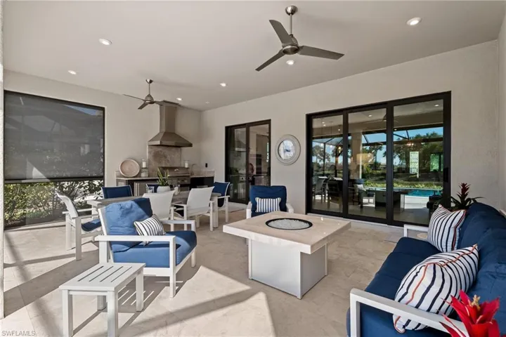 View of patio featuring an outdoor living space with a fire pit, area for grilling, a ceiling fan, and grilling area
