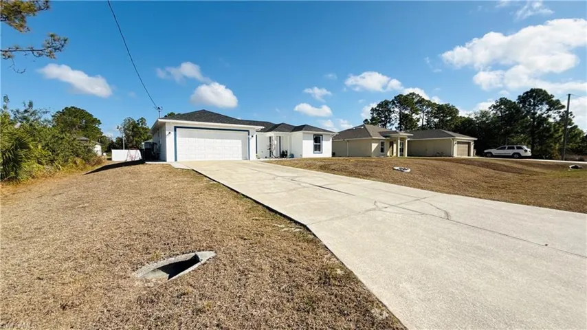 Single story home featuring driveway and an attached garage