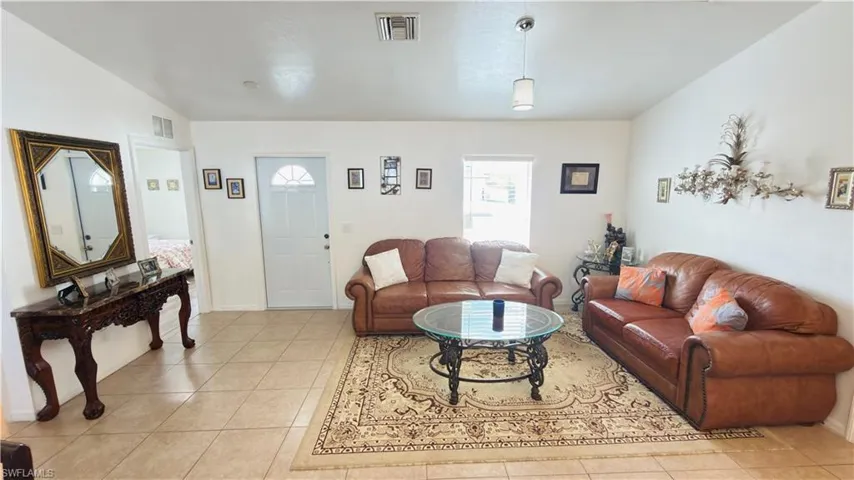 Living area featuring light tile patterned floors