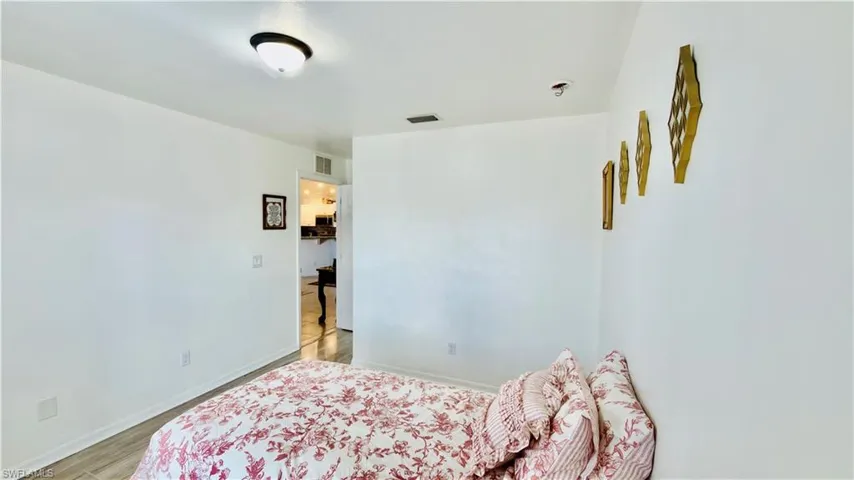 Bedroom with baseboards and light wood finished floors