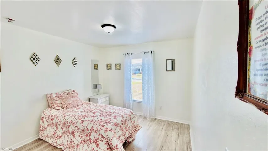 Bedroom with light wood-style floors