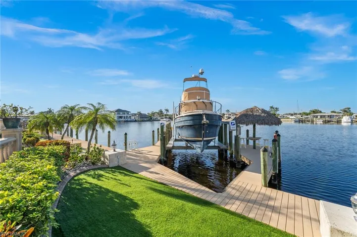 View of dock featuring a yard and a water view