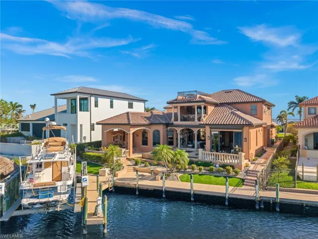 Rear view of house with a water view and a balcony