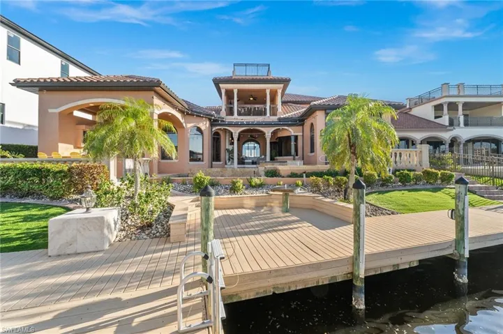 Back of property featuring a water view and a balcony