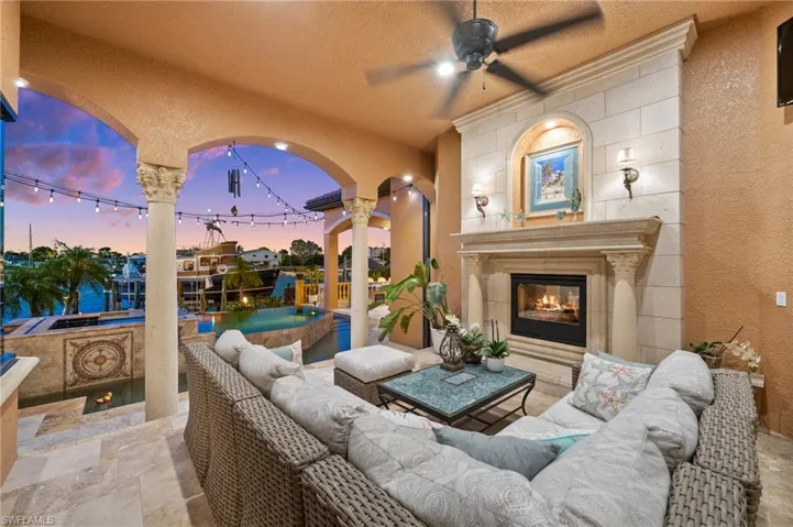 Patio terrace at dusk featuring an outdoor living space with a fireplace