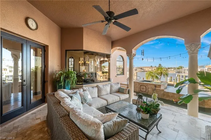View of patio with an outdoor living space, ceiling fan, and french doors