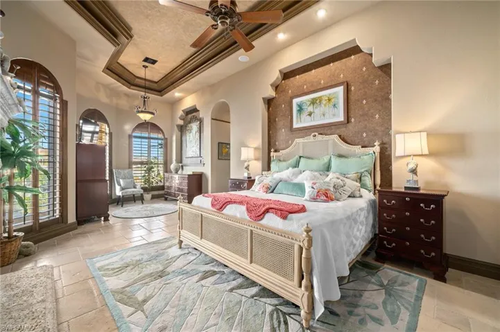 Bedroom with crown molding and a raised ceiling