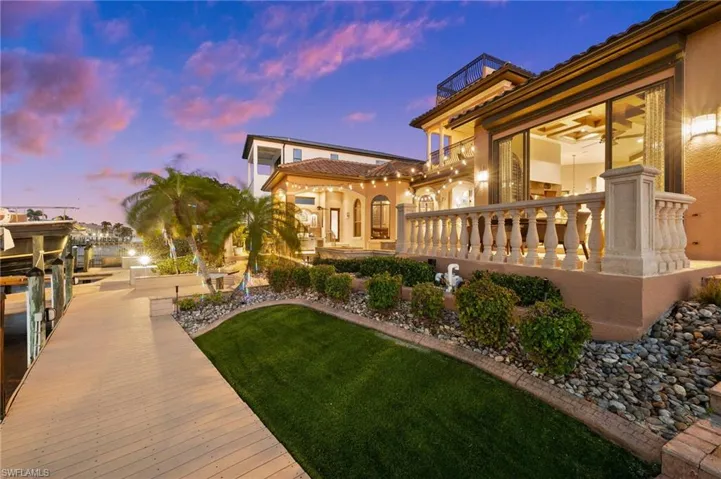 Yard at dusk with a dock and a balcony