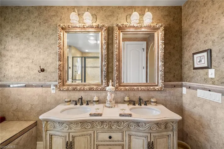 Bathroom featuring tile walls and vanity