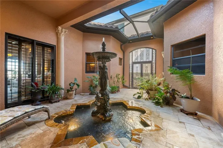 Doorway to property featuring a patio area