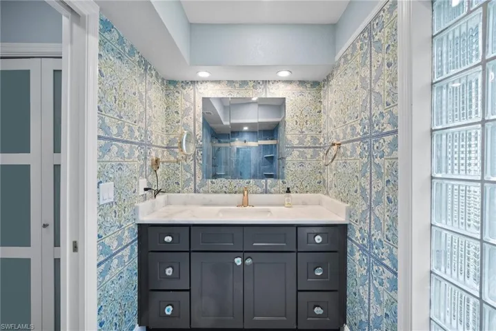 Bathroom featuring vanity and a shower with shower door