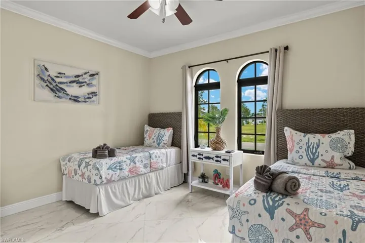 Tiled bedroom #3 featuring ceiling fan and crown molding