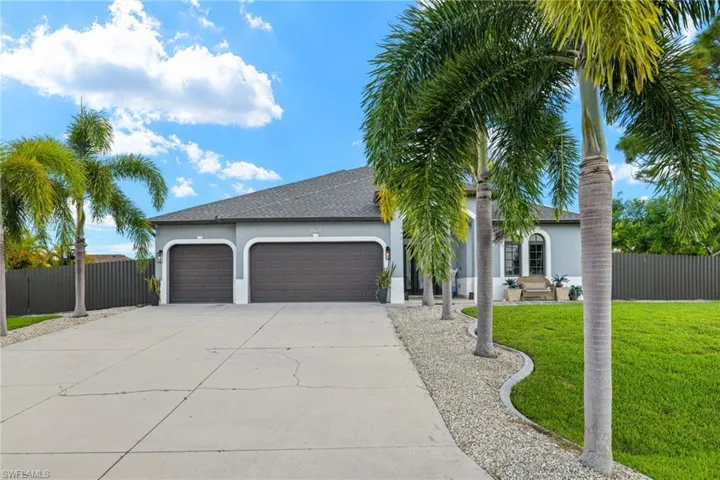 View of front of home with a front lawn and a garage