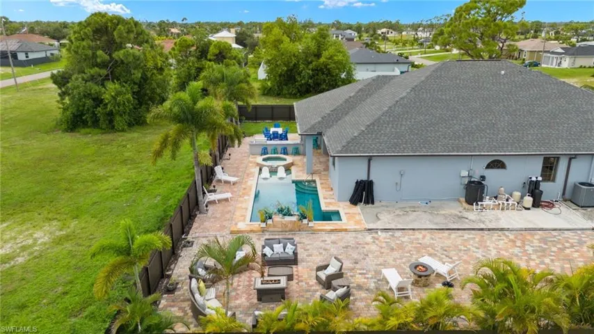 Back of property with a fenced in pool, a yard, and a patio area