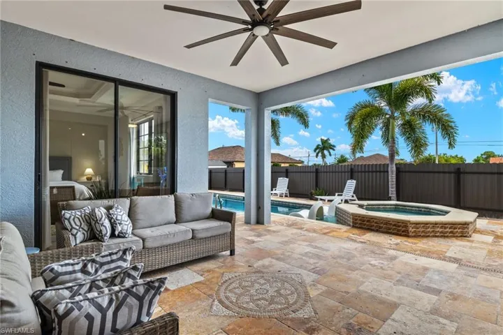 View of patio with an outdoor living space, a pool with hot tub, and ceiling fan