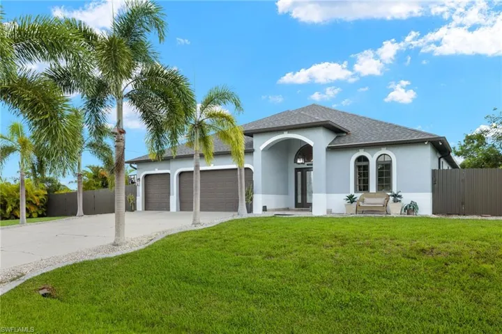 View of front of home featuring a garage and a front lawn