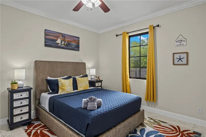 Bedroom #3 featuring ceiling fan and ornamental molding