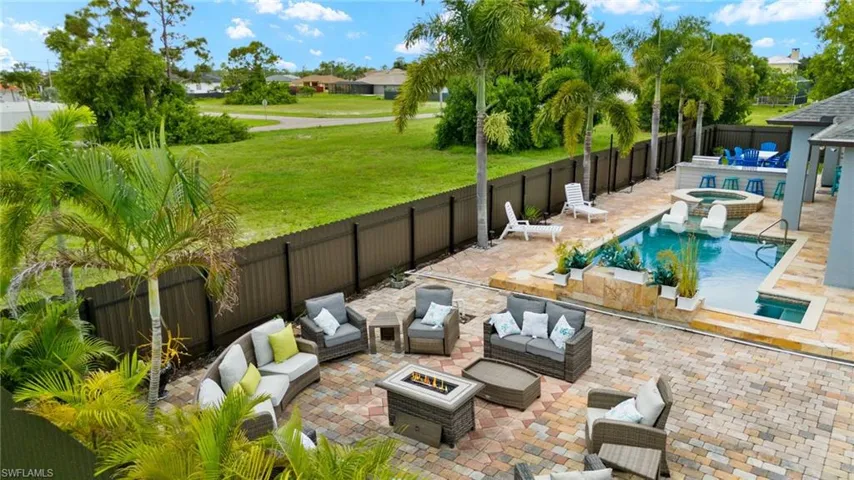 View of pool featuring an outdoor living space, a yard, and a patio
