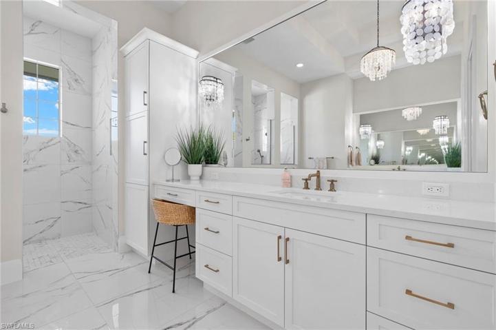 High End Fixtures, Framed Mirrors, White Cabinets and Tops, Lots of Storage.
