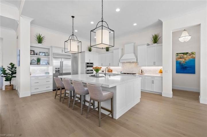 Large Kitchen with High End Appliances, Gas Cooktop, Designer Lighting, Beautiful Wood Plank Flooring.