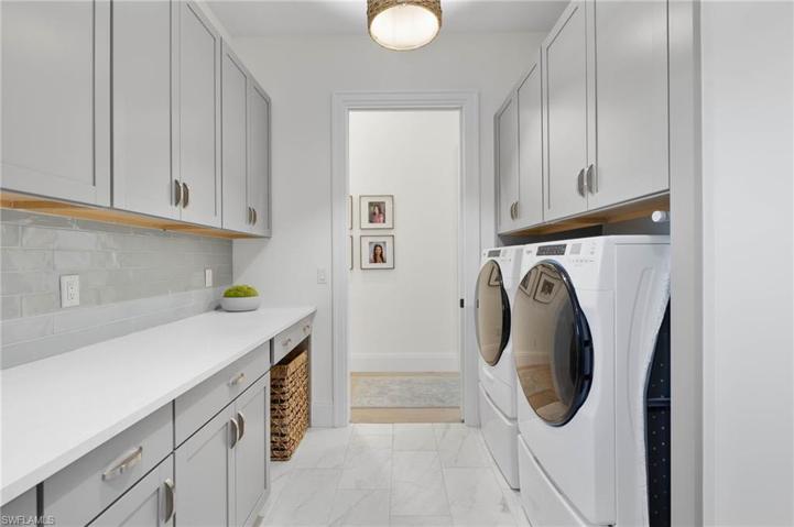 Extra Large Laundry Room with High End Appliances and Loads of Storage Space.