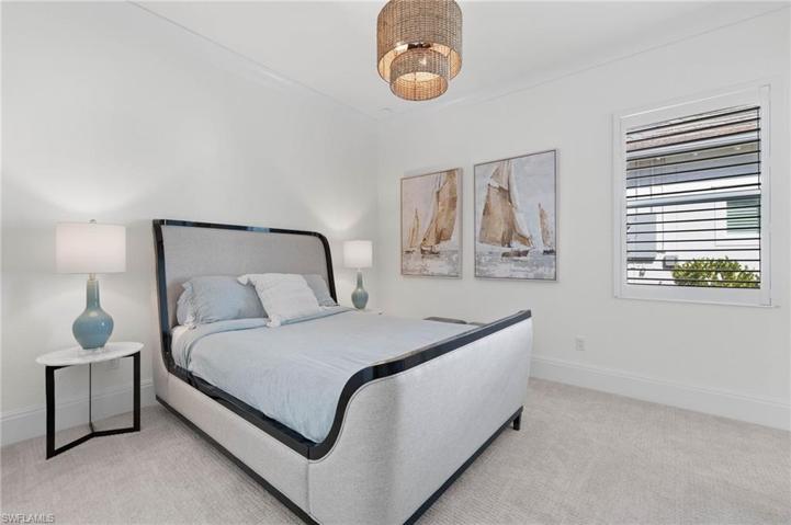 Roomy Guest Bedroom with Ensuite Full Bath, Plantation Shutters Upscale Lighting.