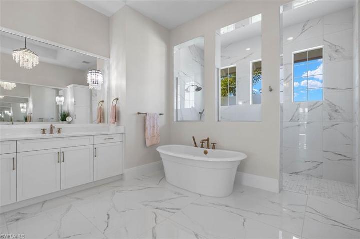 Large Master Bathroom with Separate Sinks, Large Soaking Tub, Walk-in-Shower with Multiple Heads.