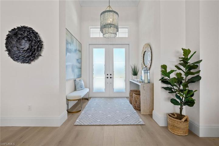 Frosted French Doors Bring in the Light While Maintaining Privacy. Exquisite Entry Lighting!