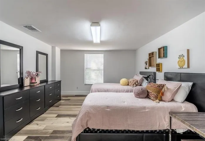 Bedroom featuring light wood-type flooring and baseboards