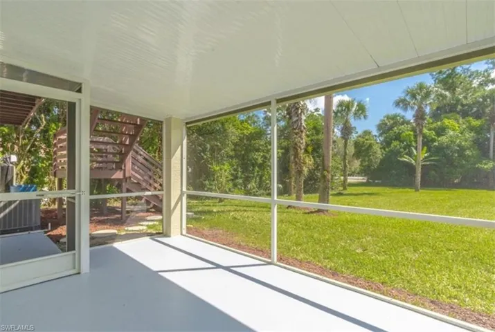Unfurnished sunroom with a patio