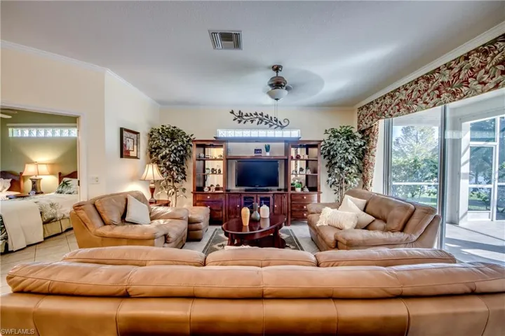 Living room with ceiling fan and crown molding