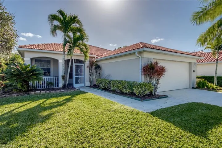Mediterranean / spanish-style home featuring stucco siding, a front yard, an attached garage, and a tiled roof