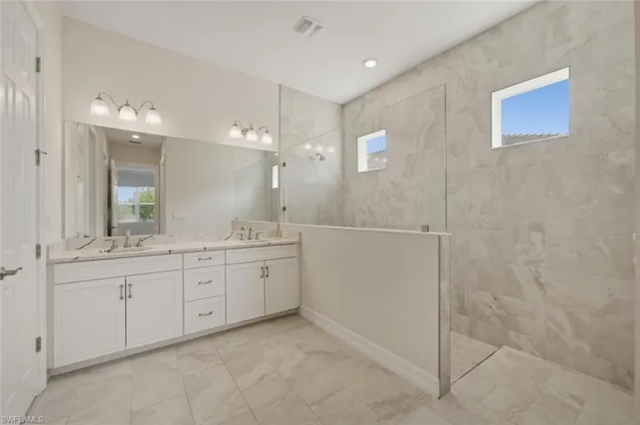 Bathroom with double vanity and a walk in shower