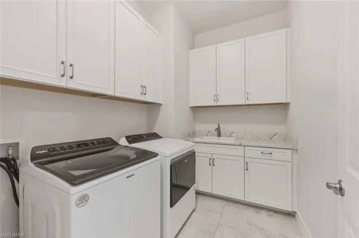 Laundry area featuring washer and dryer and cabinet space