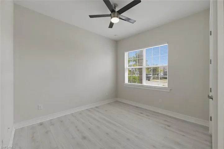 Spare room with light wood-type flooring and a ceiling fan