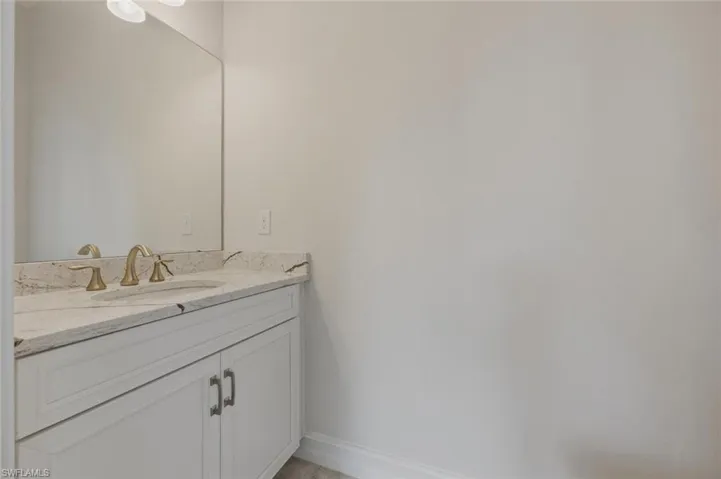 Bathroom with vanity and baseboards